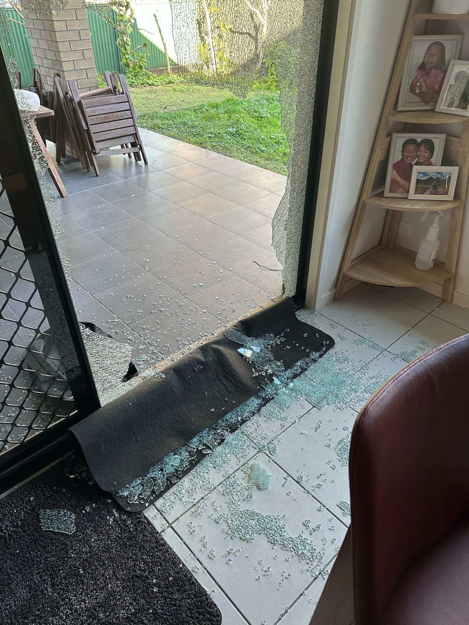 Broken sliding door glass requiring emergency repair